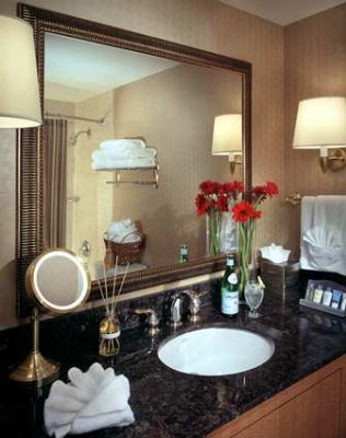 Contemporary Bathroom Featuring Granite Countertops And Curved Shower Rod.