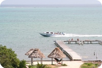 Belize Odyssey Resort - Guests On Beach & Pier Watch Water Taxi