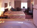 Tropicana Express - Parlor Car Suites Feature A King Bed With Pillow Top An Amazing Pool Or River View Oversized Jacuzzi Tub Refrigerator And Other Room Amenities Including A Plush Love Seat.