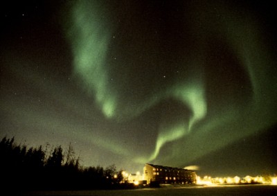Northern Lights Dancing Over The Lodge In Winter